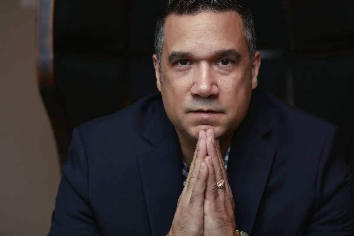 Ted Canto seated in a navy jacket and ready for a financing conversation
